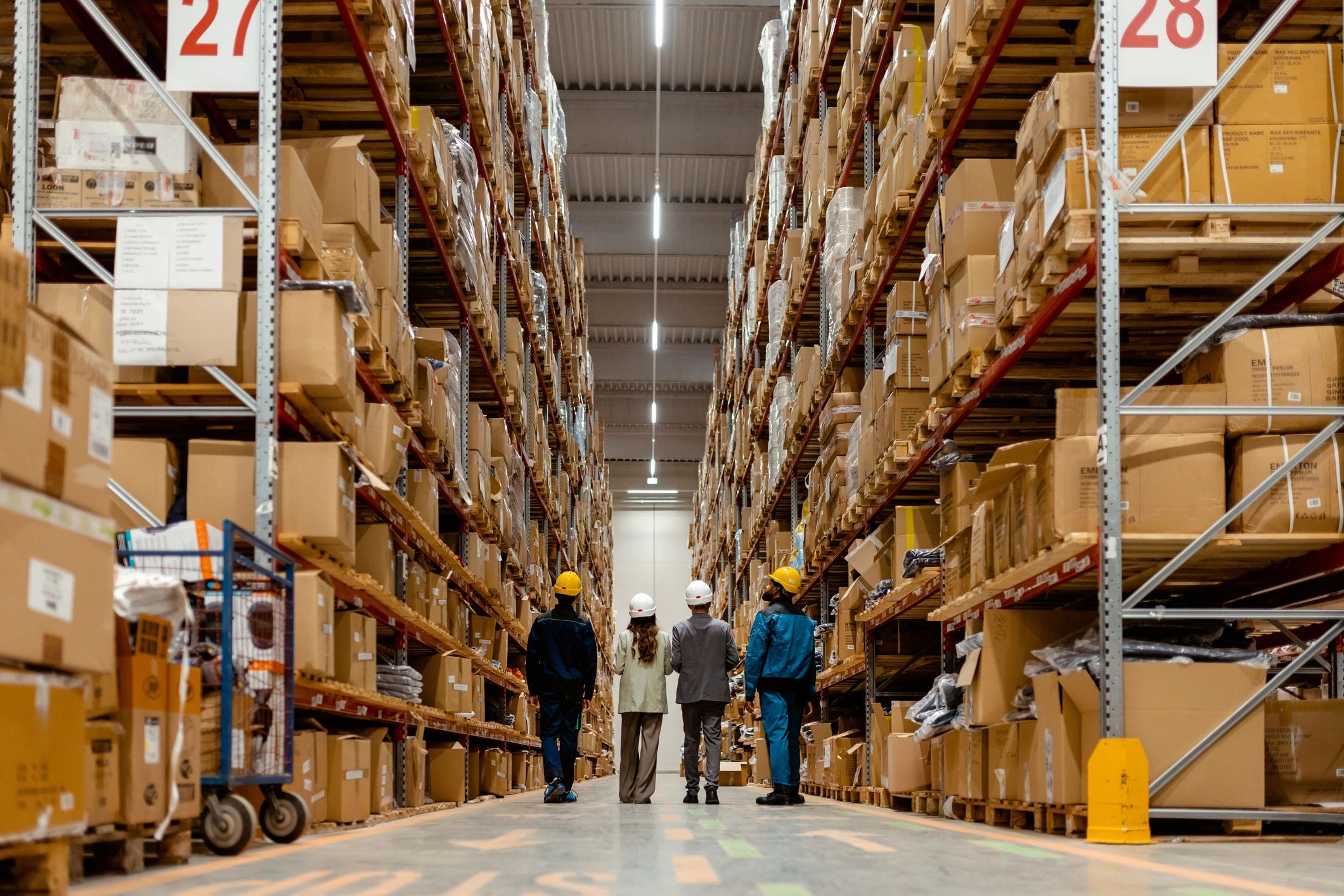 Industrial team walking through a warehouse and equipment inventory area