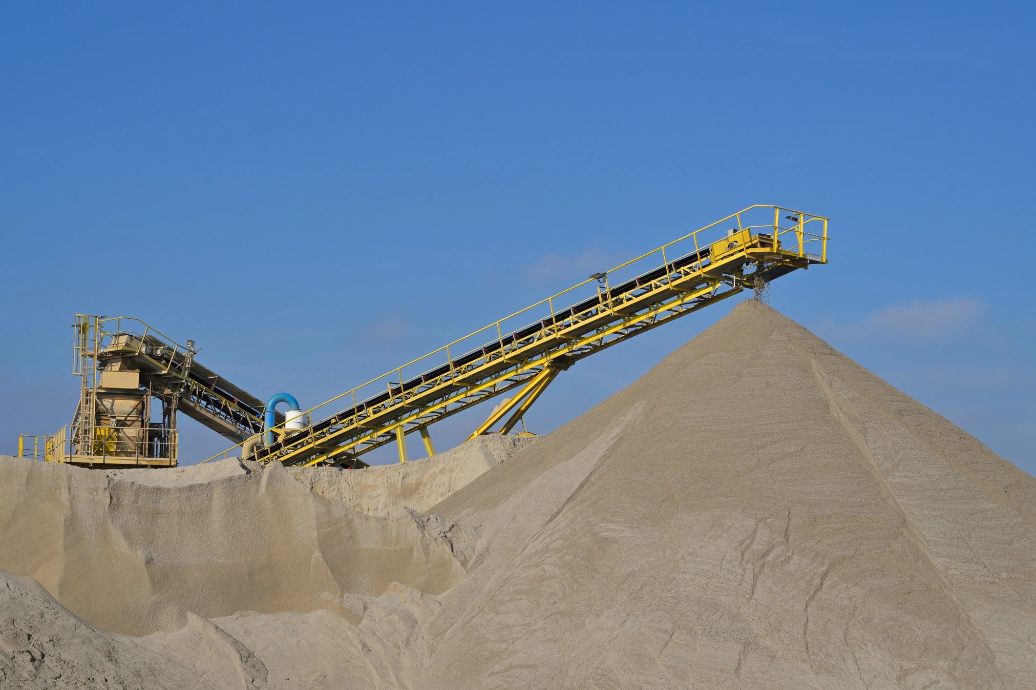 Conveyor belt moving material at an industrial mining site